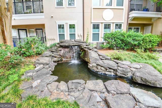 surrounding community featuring a small pond