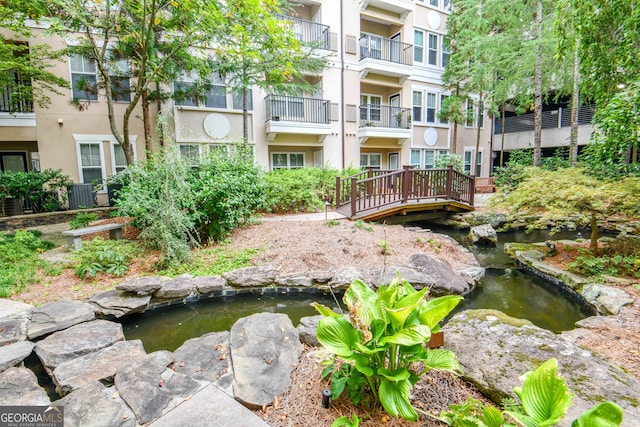 surrounding community featuring a garden pond