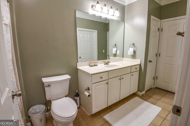 bathroom with ornamental molding, vanity, toilet, and tile patterned floors