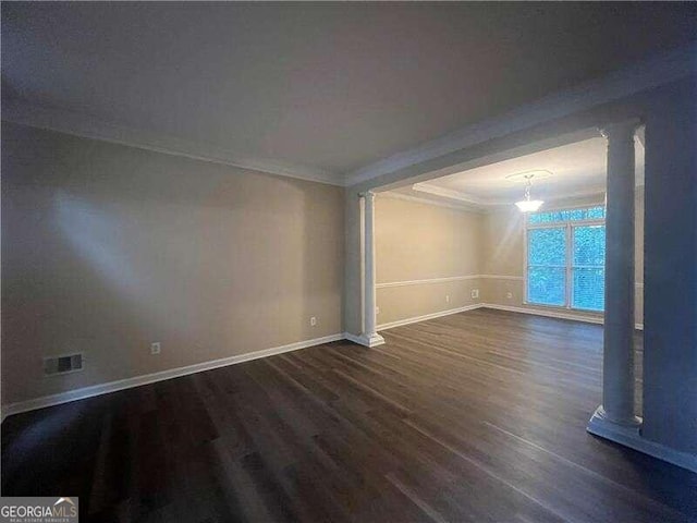 empty room with crown molding and dark wood-type flooring