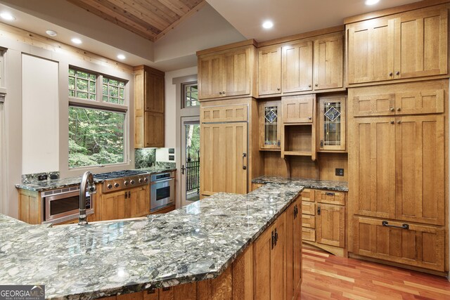 kitchen featuring light stone counters, stainless steel appliances, wooden ceiling, light hardwood / wood-style floors, and vaulted ceiling