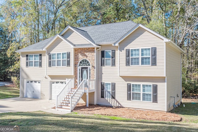 split foyer home featuring a garage and a front yard