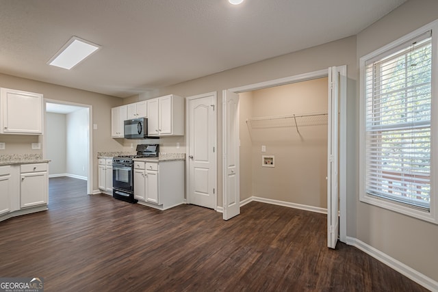 kitchen featuring dark wood-type flooring, black appliances, white cabinets, a textured ceiling, and light stone counters