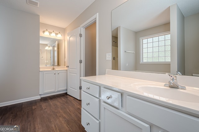 bathroom featuring vanity, a textured ceiling, and hardwood / wood-style flooring