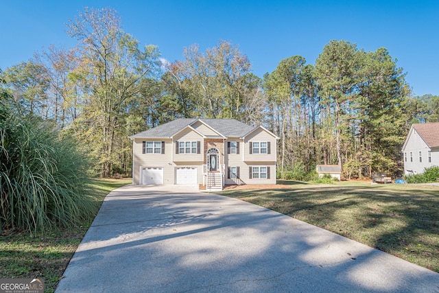 split foyer home featuring a garage and a front lawn