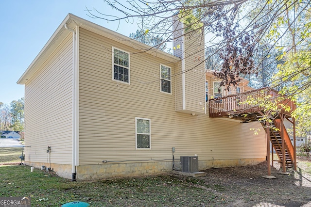 view of property exterior featuring a wooden deck and central AC