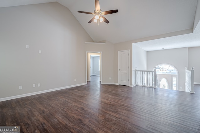 unfurnished living room with ceiling fan with notable chandelier, a textured ceiling, dark hardwood / wood-style flooring, and high vaulted ceiling