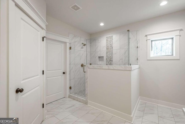 bathroom with a tile shower