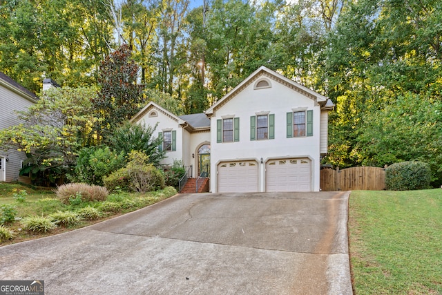 view of front of house with a garage and a front lawn