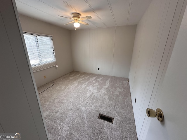 spare room featuring carpet floors and ceiling fan