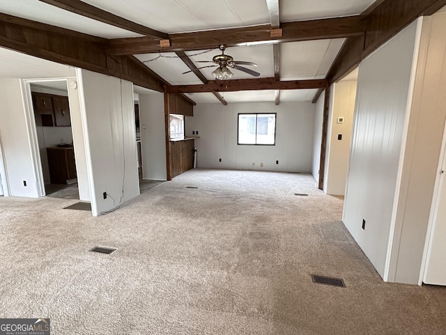 unfurnished living room featuring lofted ceiling with beams, light colored carpet, and ceiling fan