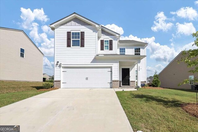 view of front of house with a garage and a front lawn