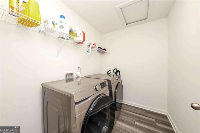 washroom featuring separate washer and dryer and dark wood-type flooring