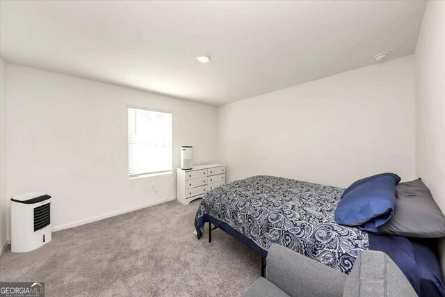 bedroom featuring light colored carpet