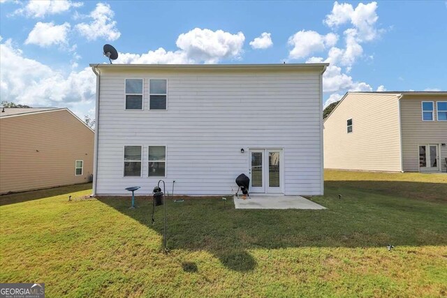 rear view of property with a patio area and a yard