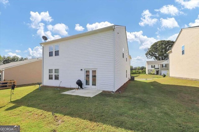 back of property featuring a lawn and a patio