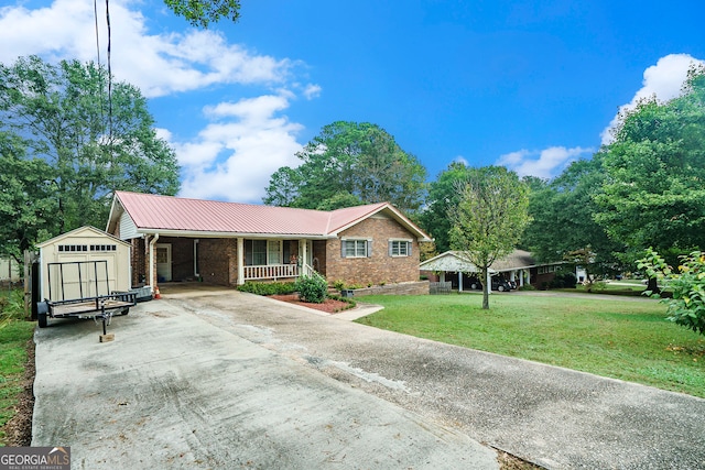 view of front of property with a shed, a front lawn, and covered porch