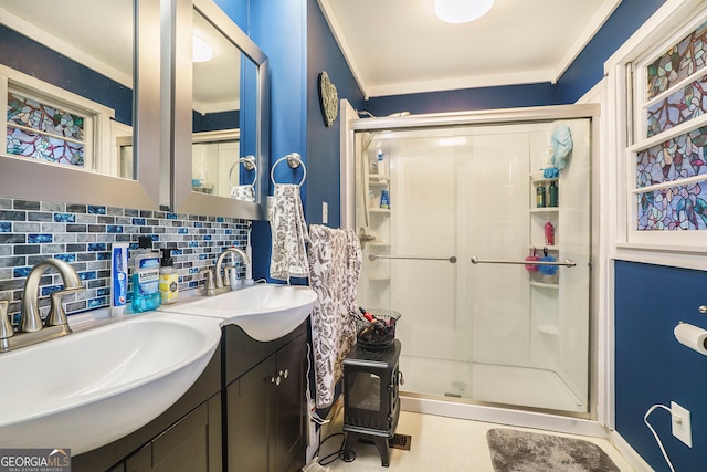 bathroom with crown molding, vanity, backsplash, and an enclosed shower