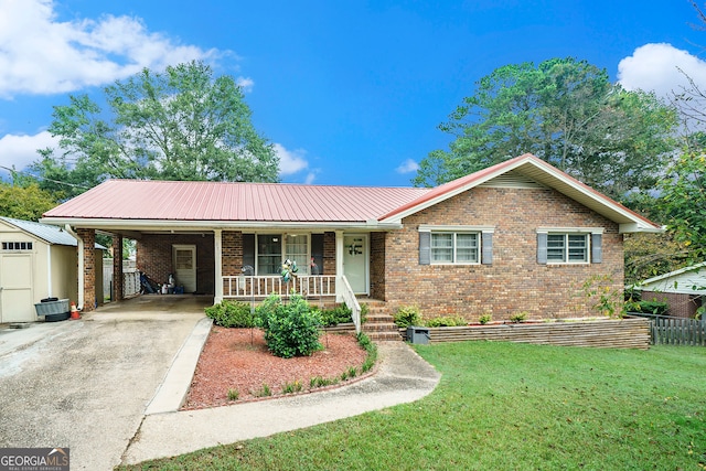 ranch-style home featuring a storage shed, a front yard, and a porch