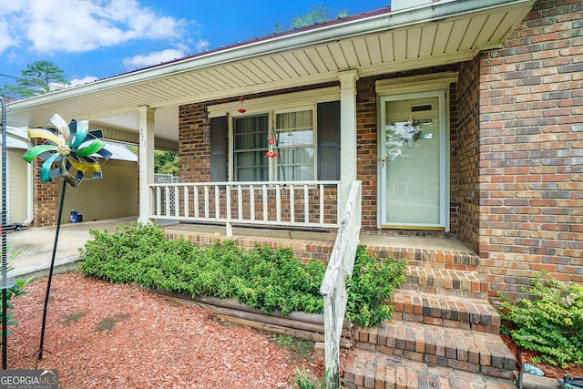 view of exterior entry with covered porch