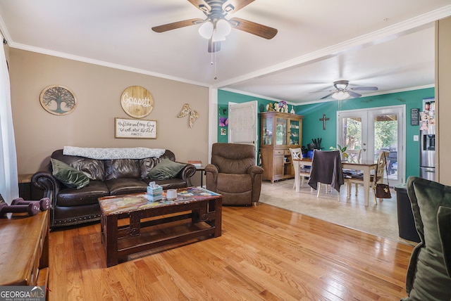 living room featuring wood-type flooring, crown molding, french doors, and ceiling fan