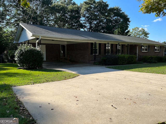 single story home with a front lawn and a carport