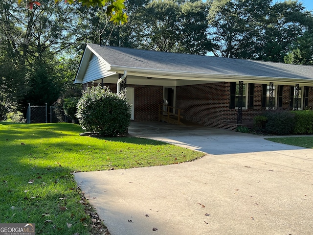 ranch-style home with a front lawn and a carport