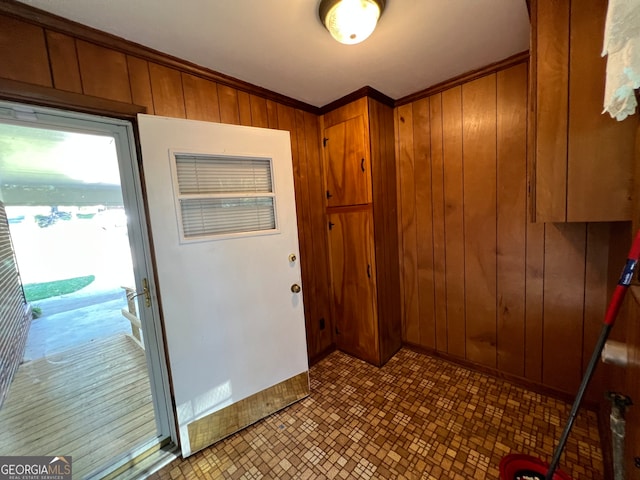 entryway featuring wooden walls