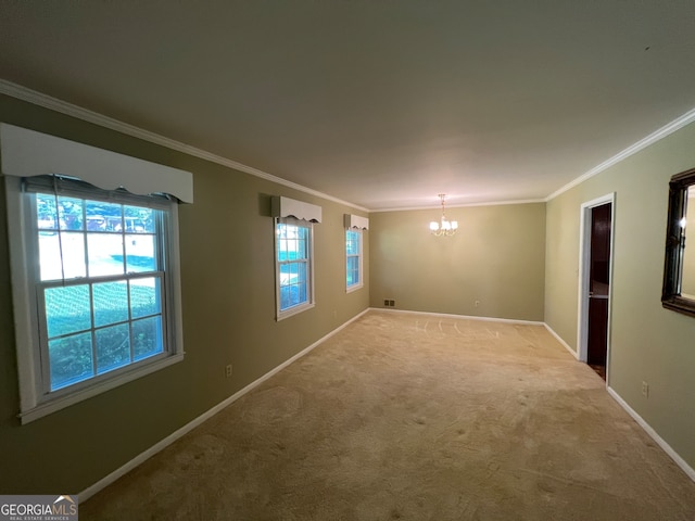 empty room featuring a chandelier, light colored carpet, and crown molding