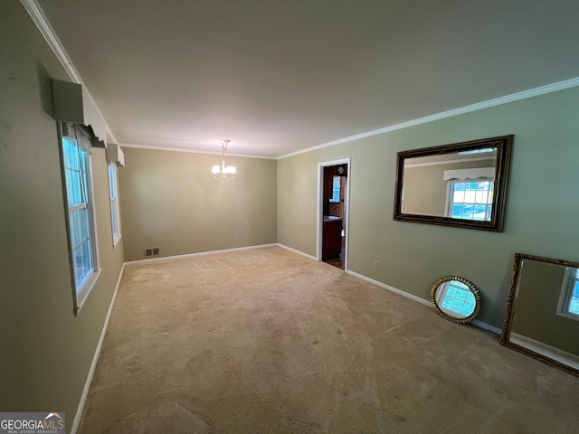 unfurnished room with crown molding, carpet flooring, and a chandelier