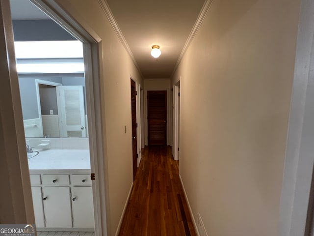 corridor featuring ornamental molding and dark hardwood / wood-style flooring