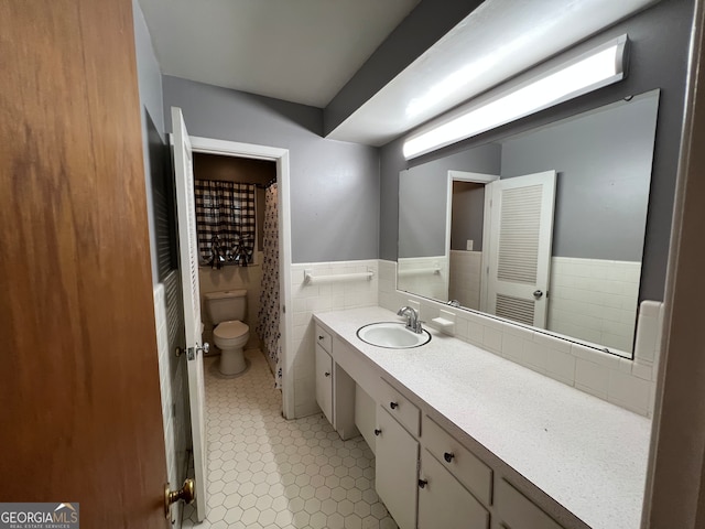 bathroom featuring tile walls, tile patterned floors, vanity, and toilet