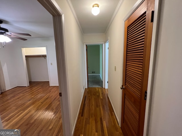 hall with crown molding and hardwood / wood-style floors