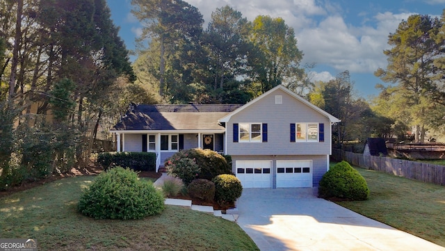 split level home featuring a garage and a front lawn