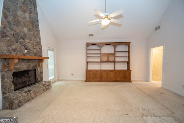 unfurnished living room featuring ceiling fan, light colored carpet, a fireplace, and high vaulted ceiling