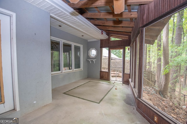 unfurnished sunroom with lofted ceiling