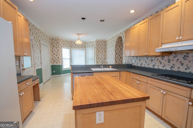 kitchen featuring sink, a kitchen island, crown molding, butcher block countertops, and black stovetop