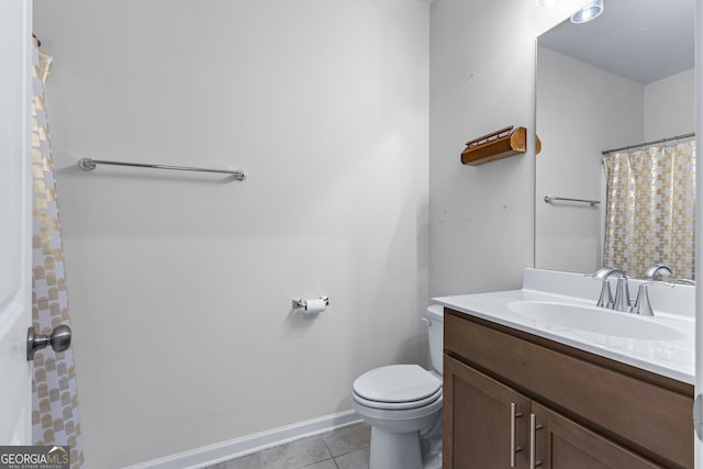 bathroom with vanity, toilet, and tile patterned flooring