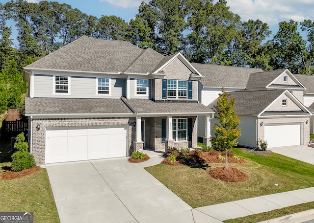 craftsman house featuring a front yard and a garage