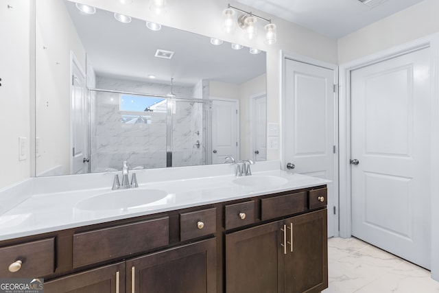 bathroom with vanity and a shower with shower door