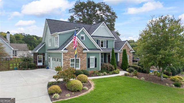 craftsman-style house featuring a garage and a front yard