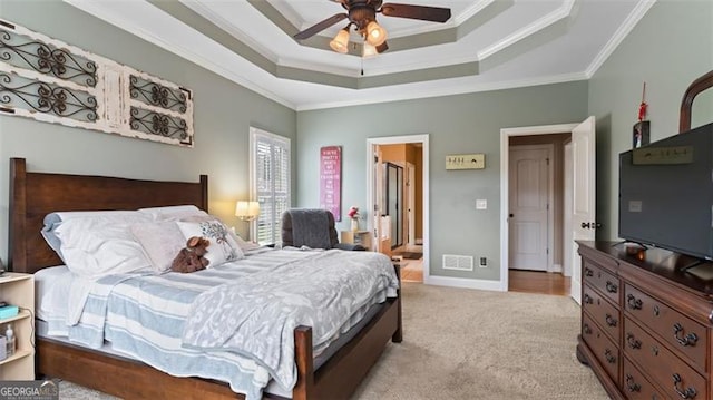 bedroom featuring crown molding, ceiling fan, and light colored carpet