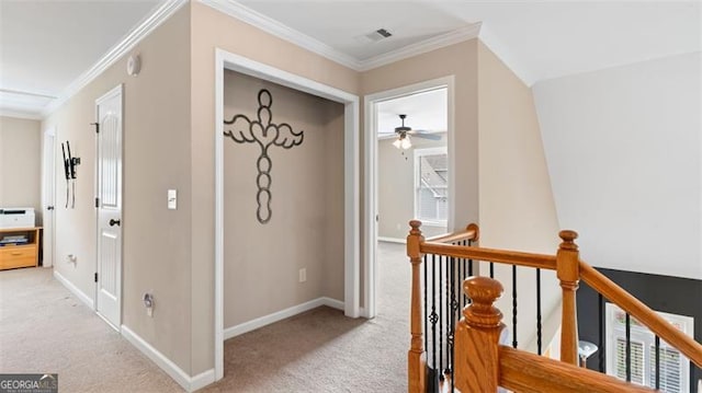 hallway with ornamental molding and light carpet