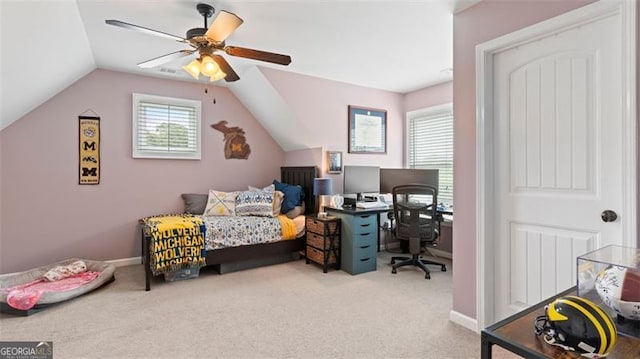 carpeted bedroom with vaulted ceiling and ceiling fan