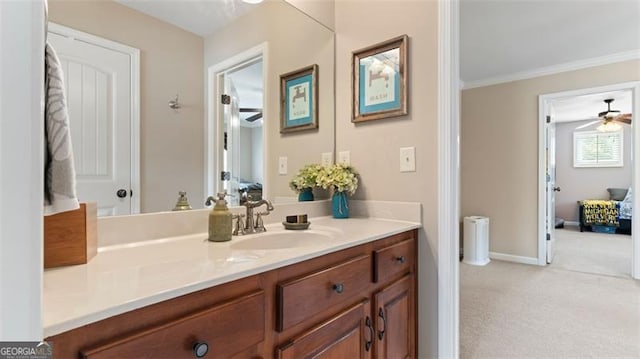 bathroom with ornamental molding, ceiling fan, and vanity