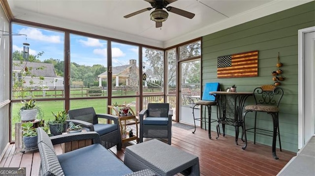 sunroom / solarium featuring ceiling fan