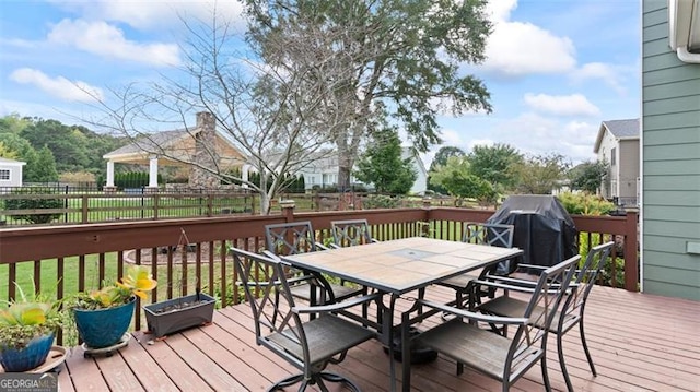 wooden deck featuring a grill