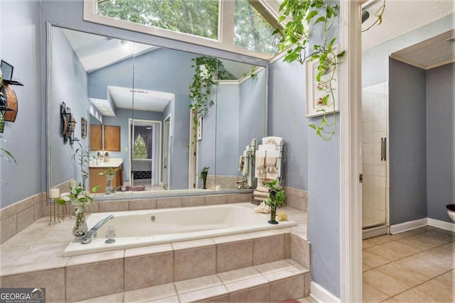 bathroom featuring vanity, plus walk in shower, and tile patterned floors