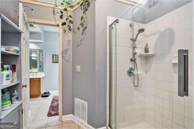 bathroom with vanity, tile patterned flooring, and a shower with shower door