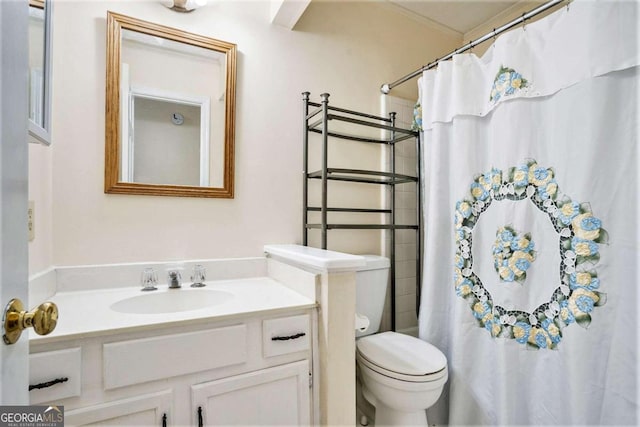 bathroom featuring walk in shower, vanity, and toilet